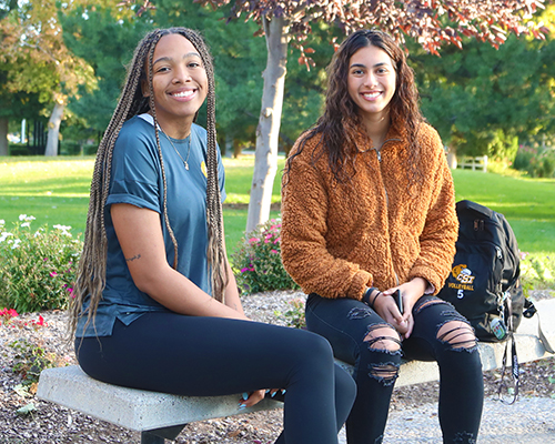 Two students sitting on a bench