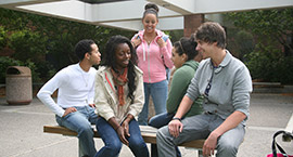 A group of five students talking