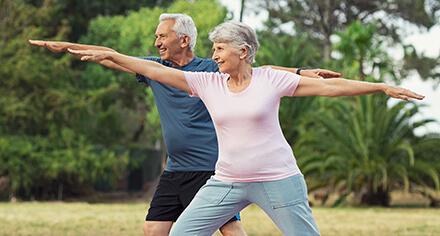 older couple doing a yoga pose