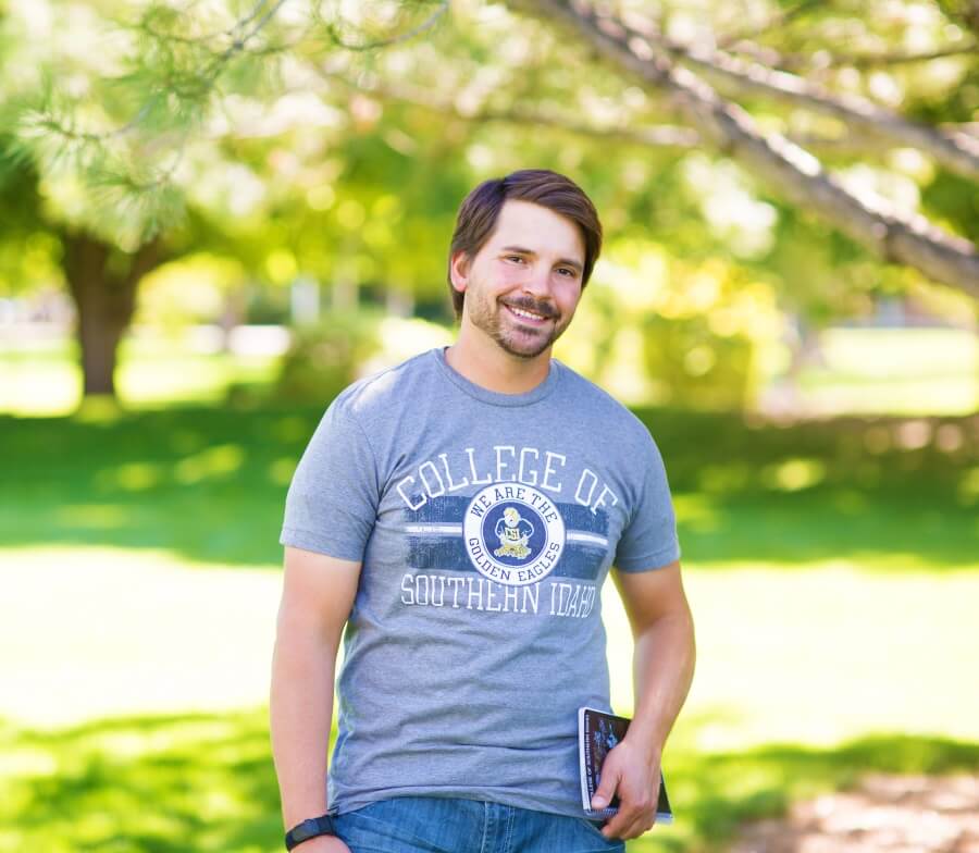 Adult student in front of CSI sign