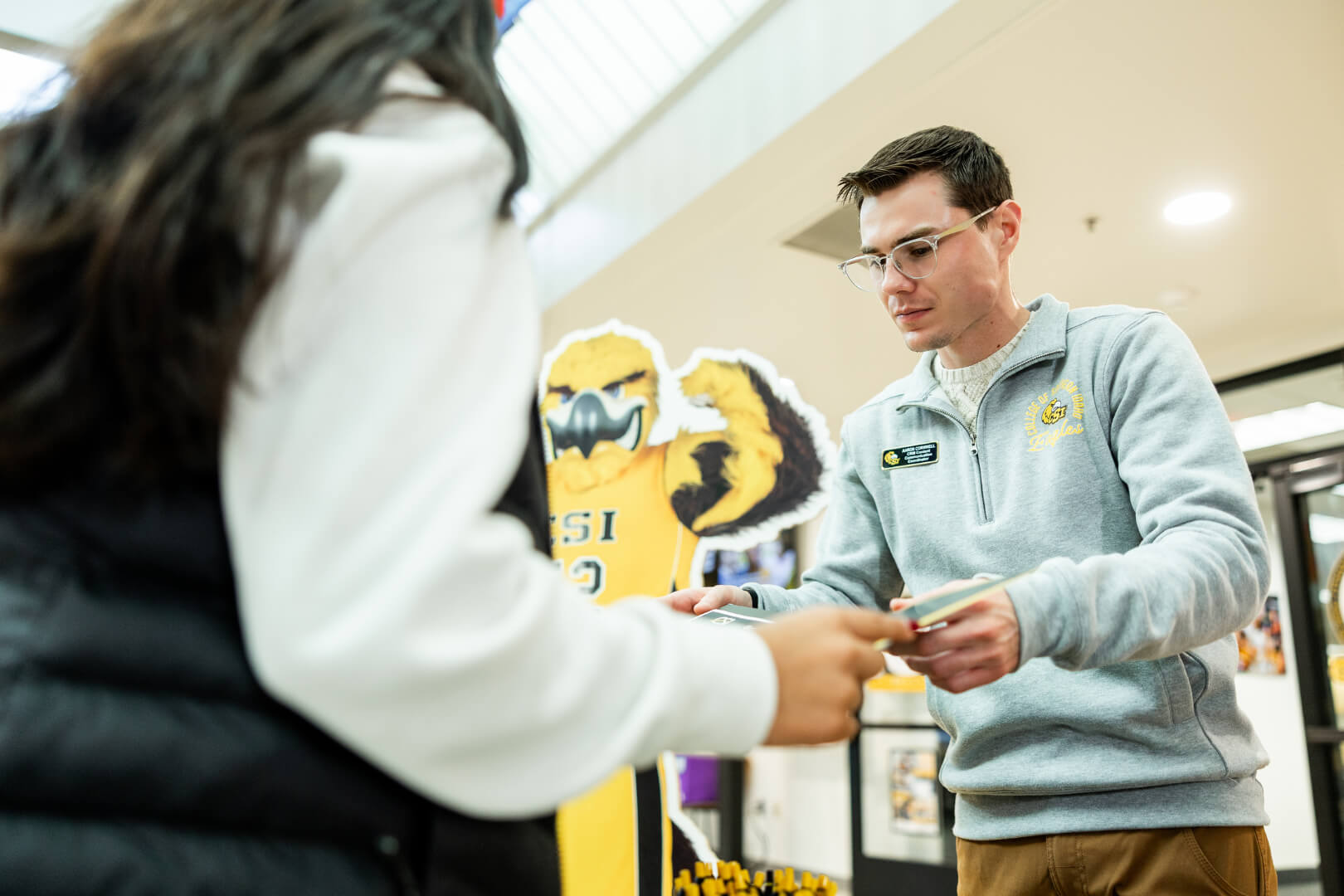 a check-in booth with enrollment specialists on hand to answer questions