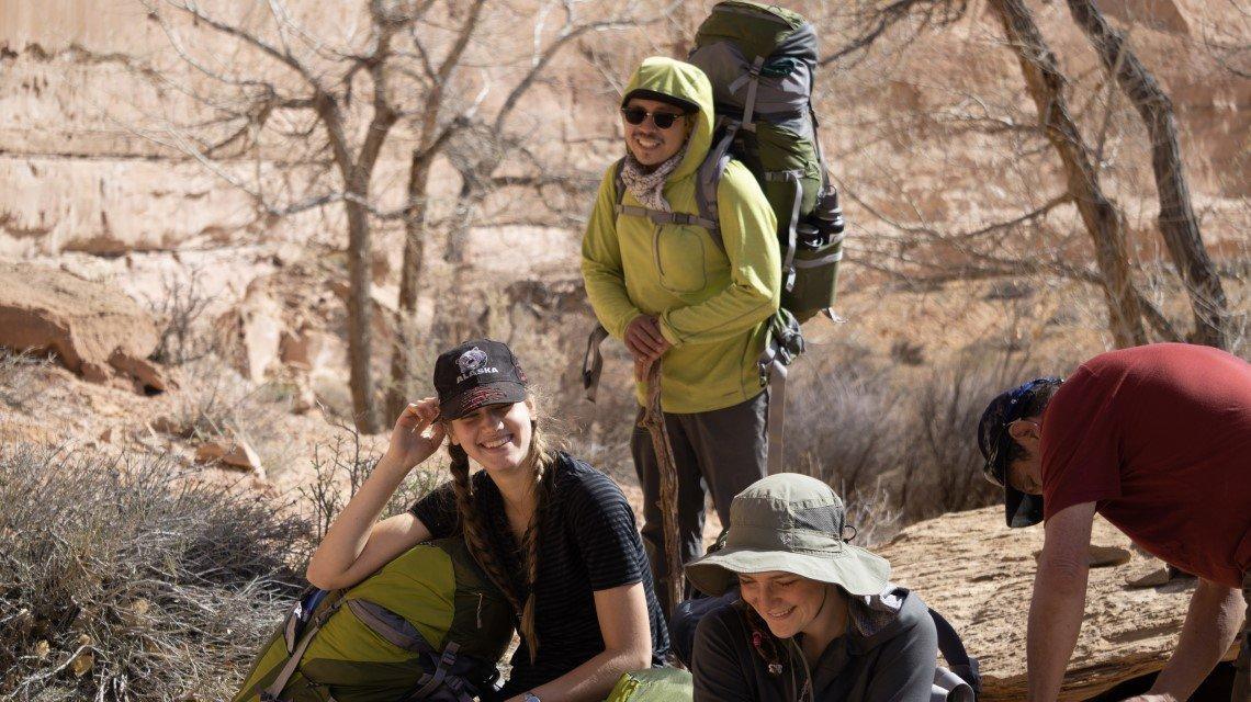 students laughing while camping