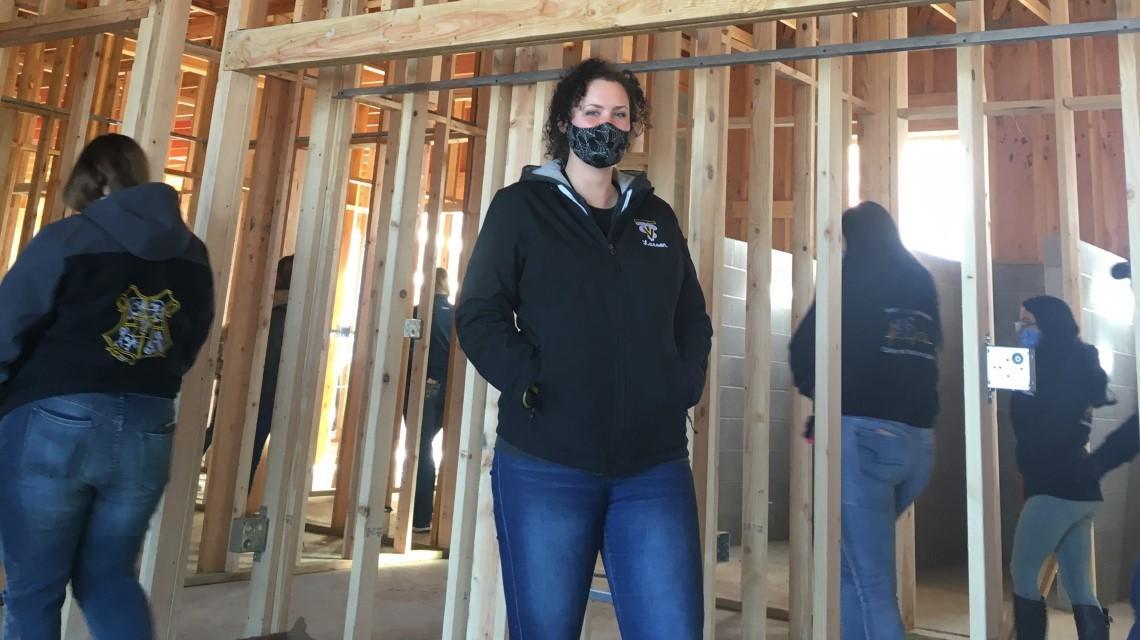 student standing inside construction building