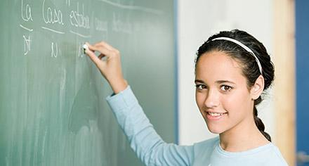 woman writing on chalkboard