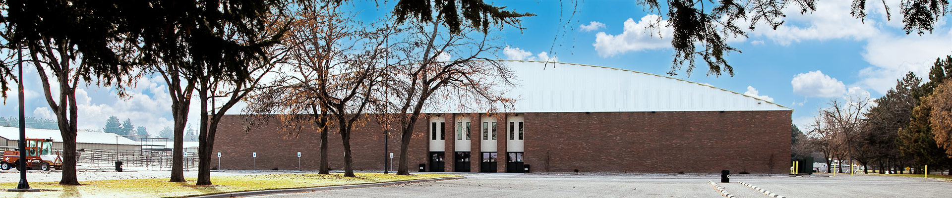 Large brick building with large parking lot outfront
