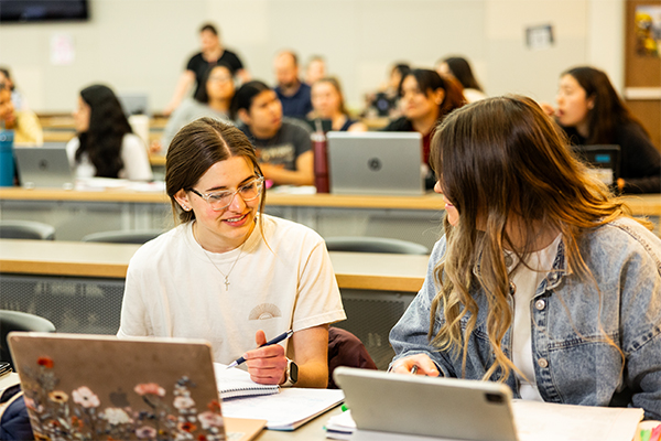 Adult student in front of CSI sign
