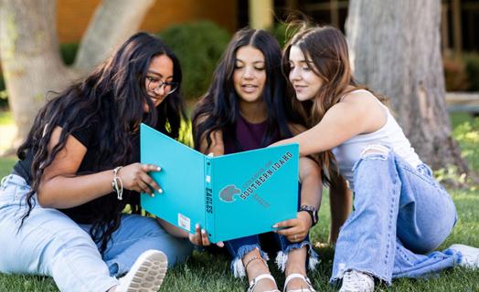 Students sitting together on campus looking at each other