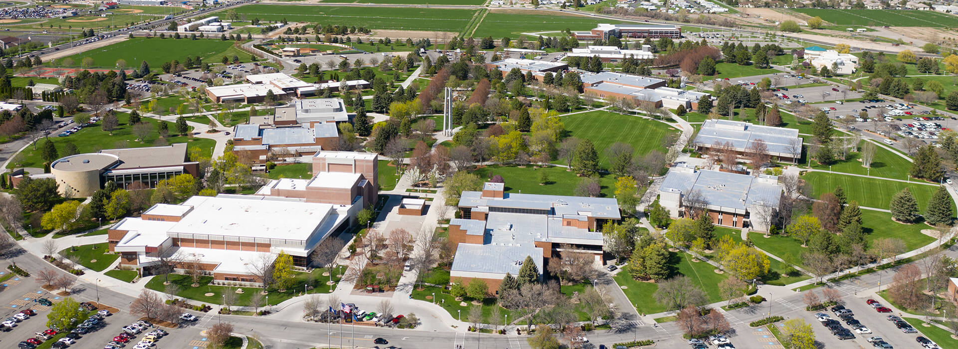 Aerial photo of campus facing towards the canyon. Trees, roofs and the bell tower are all in view