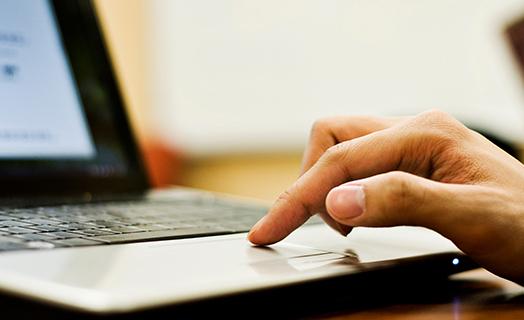 student paying bills on a computer