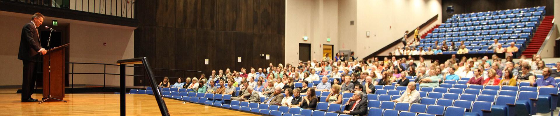 auditorium of people listening to a speaker