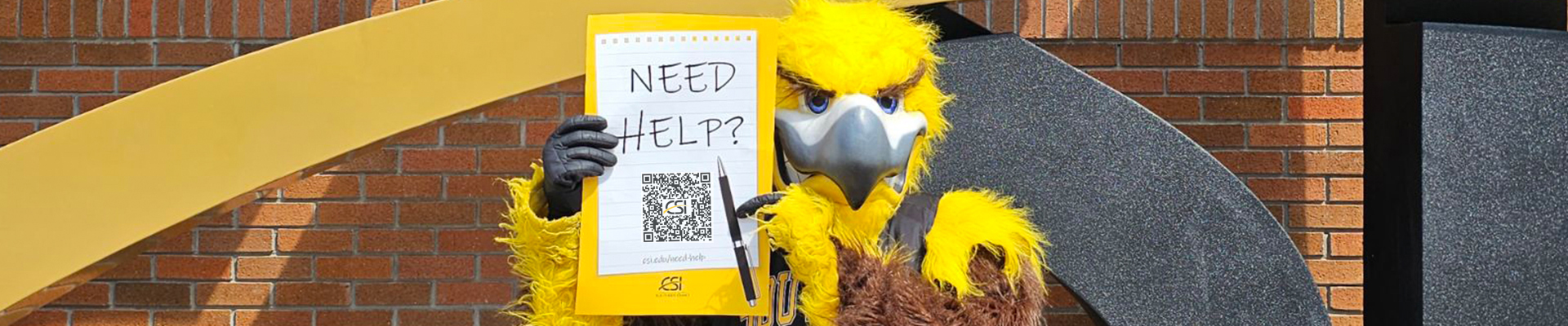 Gilbert holding up a Need Help poster