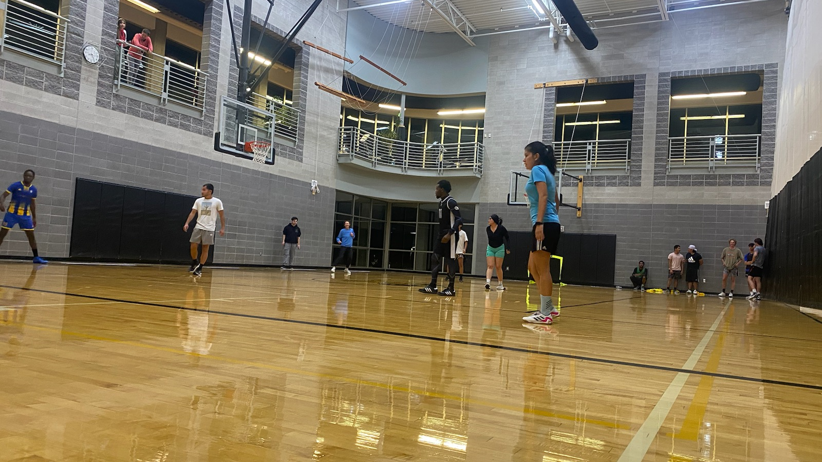 Students playing basketball inside CSI gym