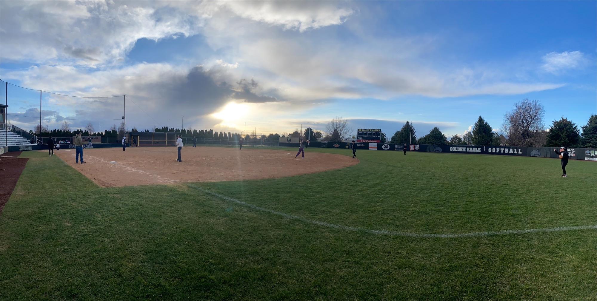 Students practicing on the softball field