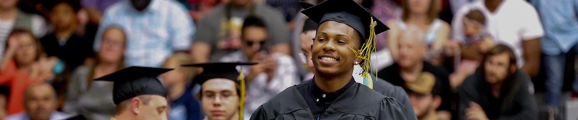 Graduating students at their commencement ceremony, wearing caps and gowns