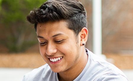 student on campus smiling