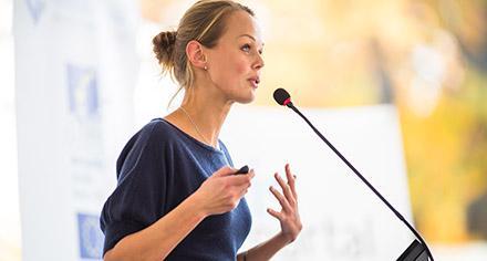 woman speaking at podium