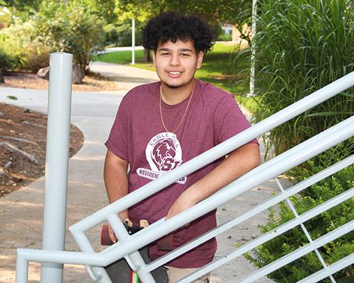 student-holding-skateboard