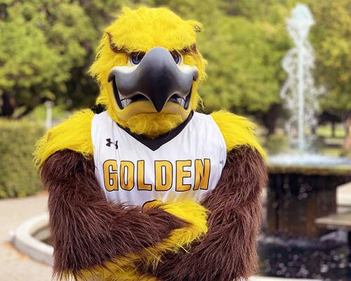 CSI Mascot posing in front of fountain