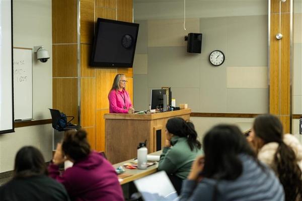 Instructor standing at a teaching station.