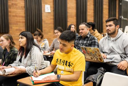 A classroom with students taking notes.