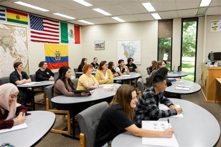 A classroom full of people sitting at tables.