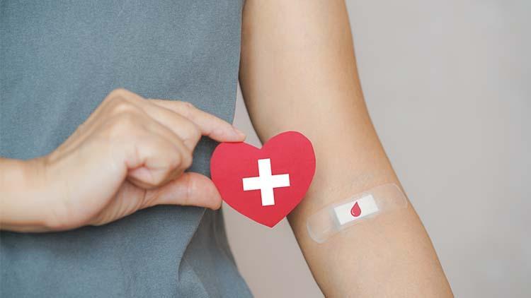 arm with red cross heart and blood drive