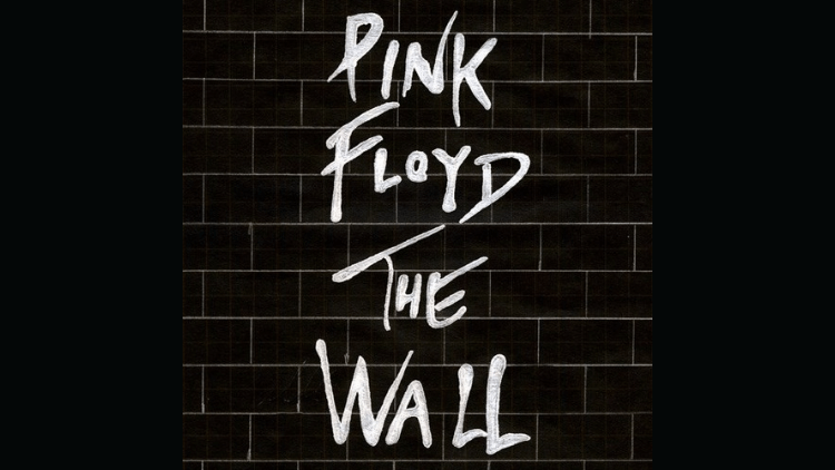 A black brick wall with the words "Pink Floyd the wall" painted on